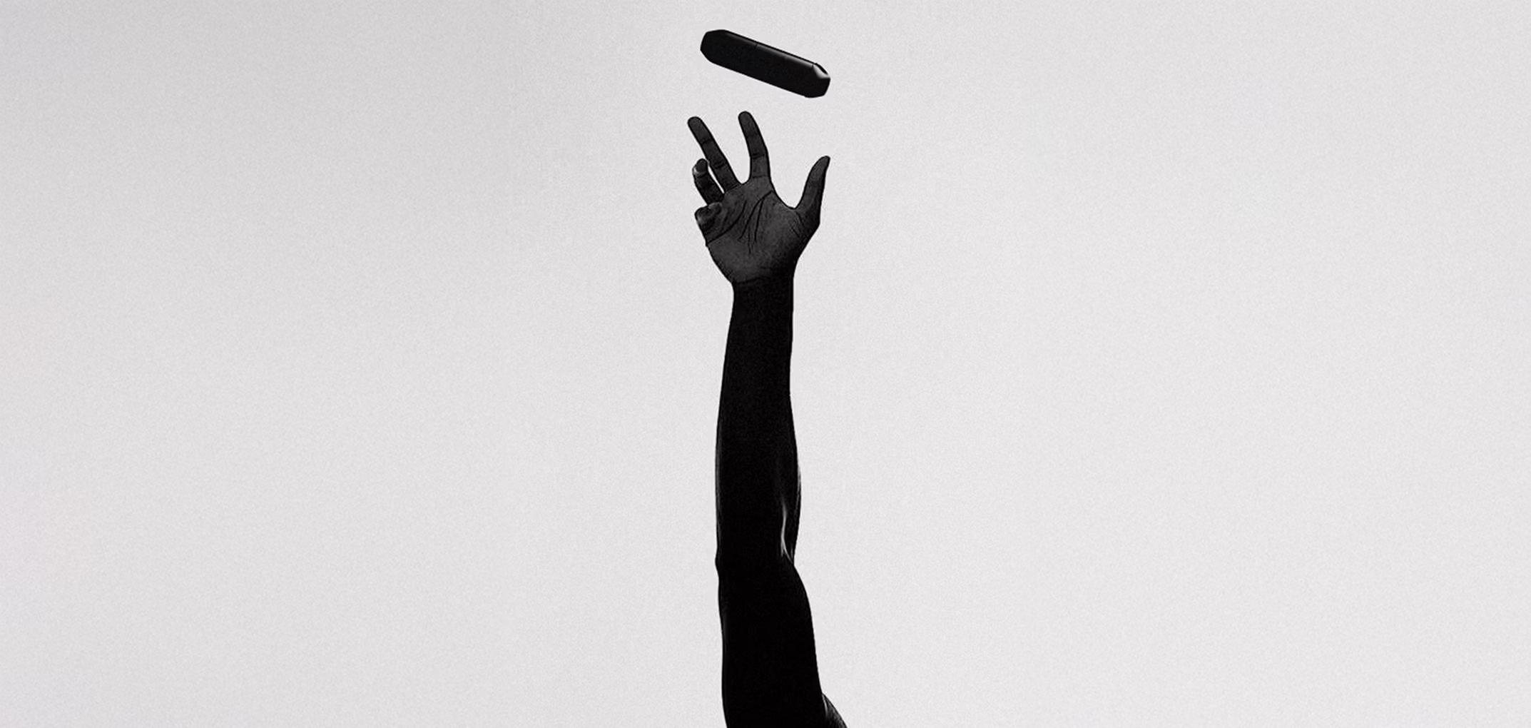 A raised hand and a Halia inhaler in the air above it