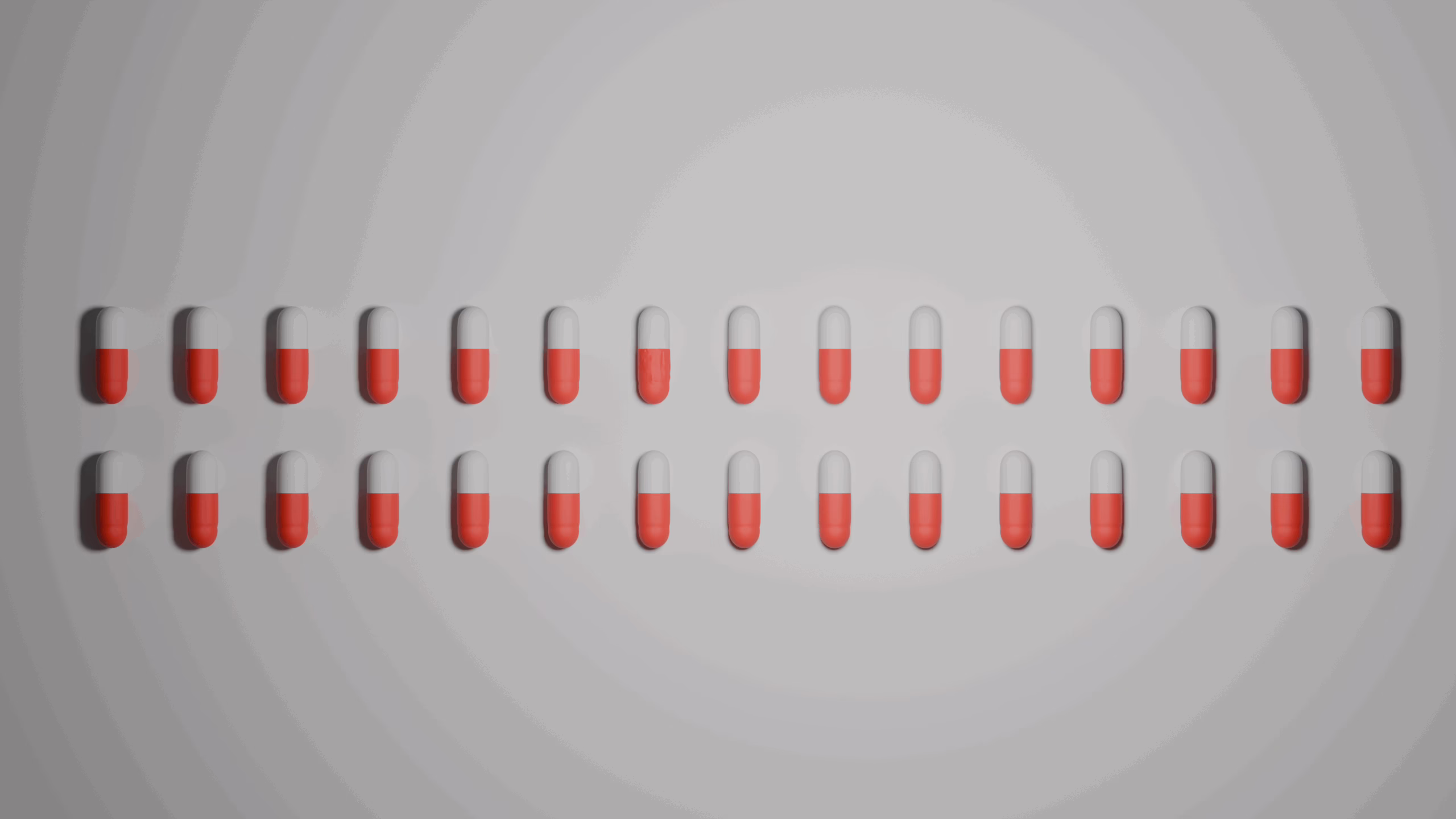 Two rows of capsules under light from above