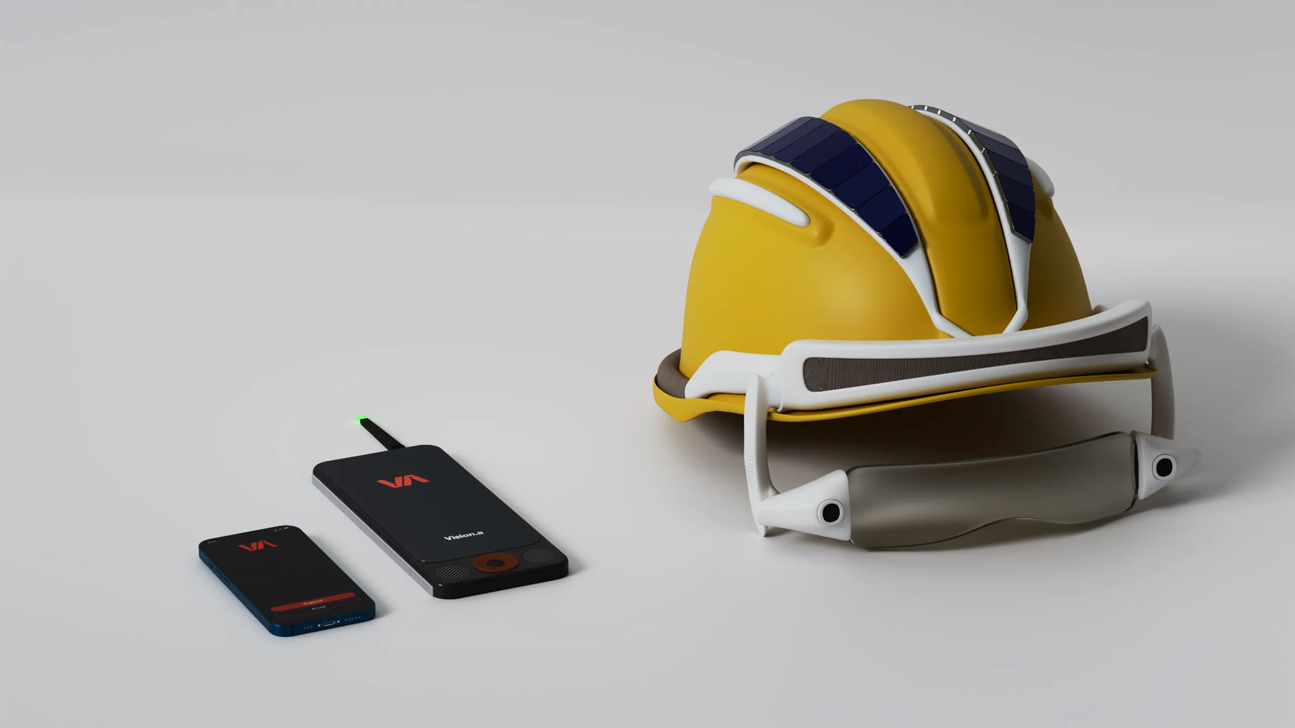 The Vision.A kit on a white table: the helmet with its visor, the belt sensor and the phone